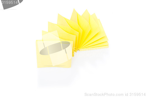 Image of Blank yellow sticky note on block