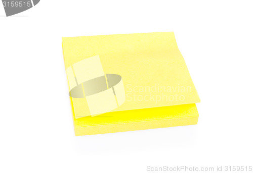 Image of Blank yellow sticky note on block