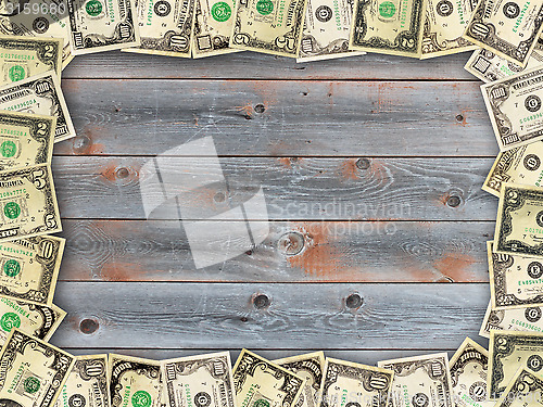 Image of Frame from the dollars on the wooden board background