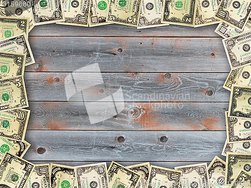 Image of Frame from the dollars on the wooden board background