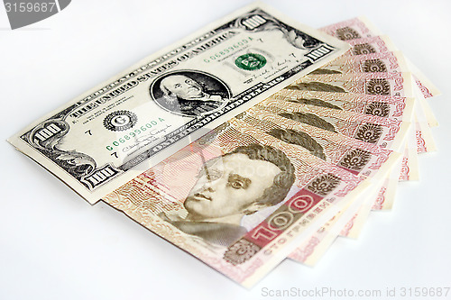 Image of 100 dollars and grivnas banknotes isolated on dark background