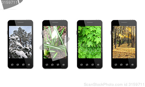 Image of four smart-phones with colored images of seasons