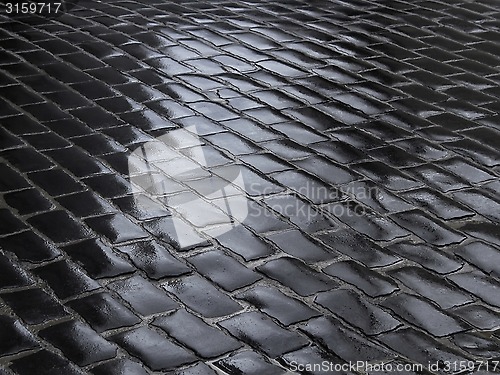 Image of Fragment of wet cobbled road