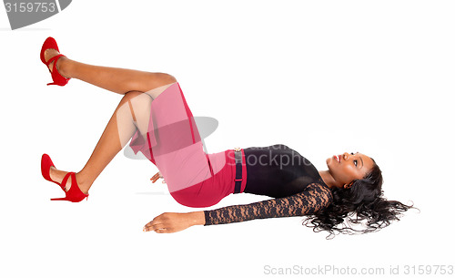 Image of Black woman lying on floor.