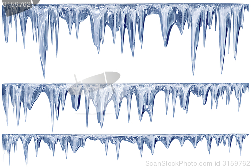 Image of set of hanging thawing icicles of a blue shade