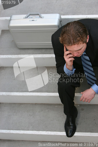 Image of Businessman talking on cell