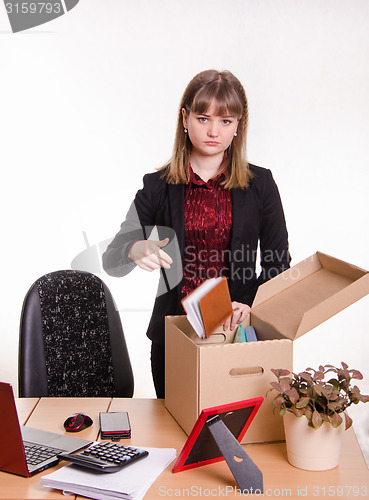 Image of Dismissed girl in office throws their stuff a box