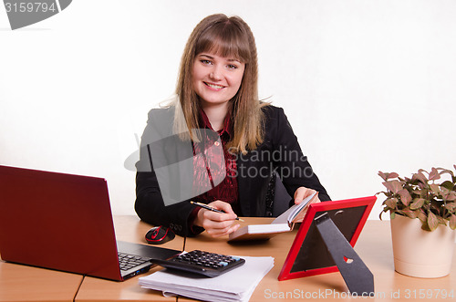 Image of Joyful Girl sitting at office table