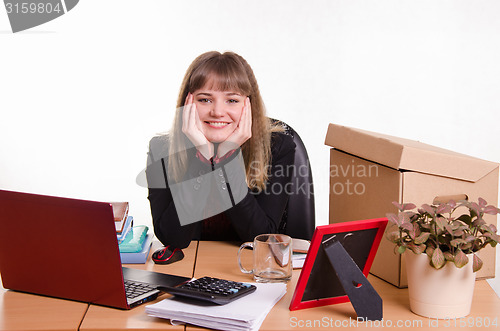 Image of Pretty teenage girl sitting at office desk