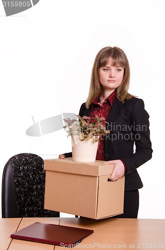 Image of Dismissed girl in office with things hands of
