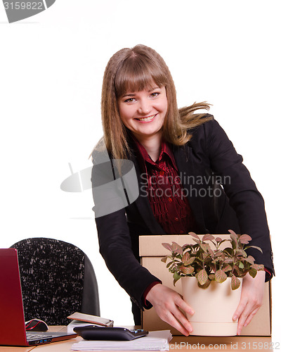 Image of Girl in office puts flower room on your desktop