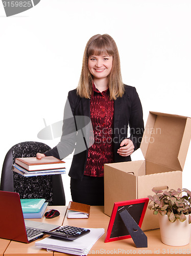 Image of New employee in the office arranges personal belongings