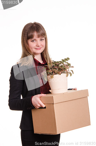 Image of Portrait of a girl with big box and potted plant in hands