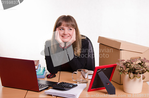 Image of Dreamy girl sitting at office desk