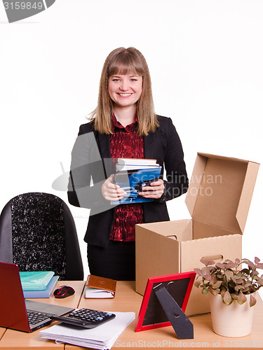 Image of New employee in the office examines their stuff