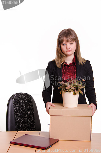 Image of Dismissed girl in office to collect things a box