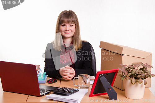 Image of Business woman sitting at office table