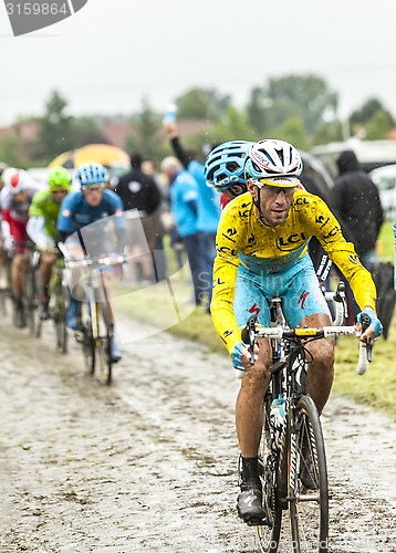 Image of Vincenzo Nibali - Yellow Jersey on a Cobbled Road