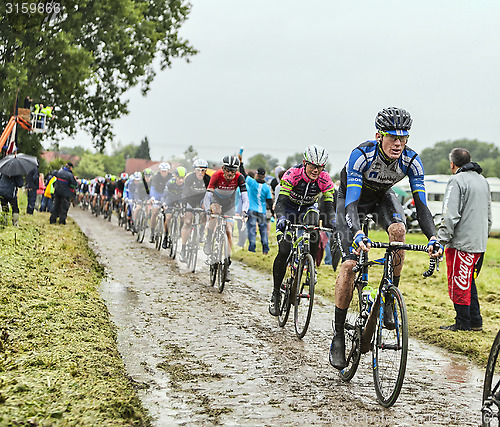 Image of The Peloton on a Cobbled Road- Tour de France 2014