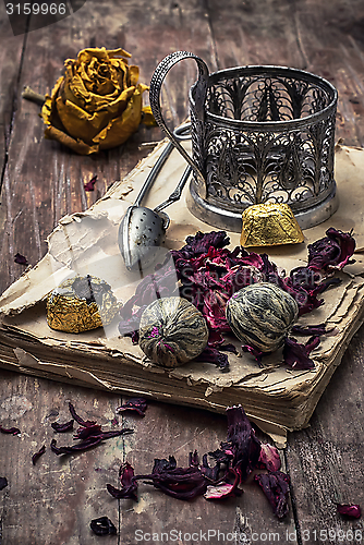 Image of tea accessories amid frayed books