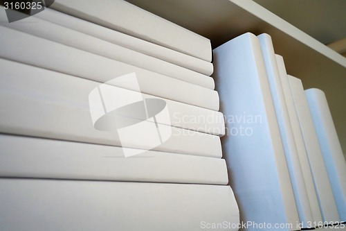 Image of Shelf with white books