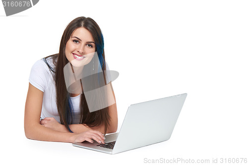 Image of Woman lying on the floor with laptop