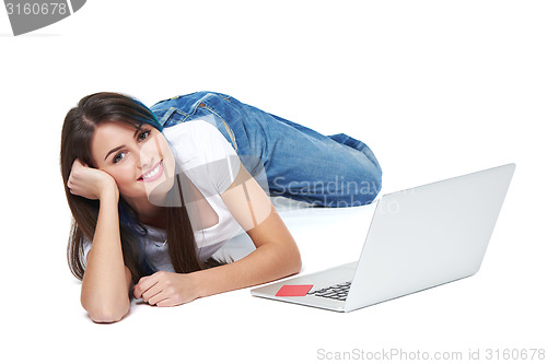 Image of Woman lying on the floor with laptop