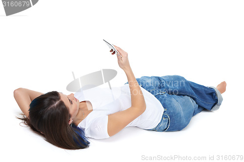 Image of Woman lying on her back and using phone