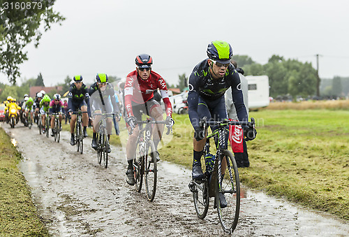 Image of The Peloton on a Cobbled Road- Tour de France 2014