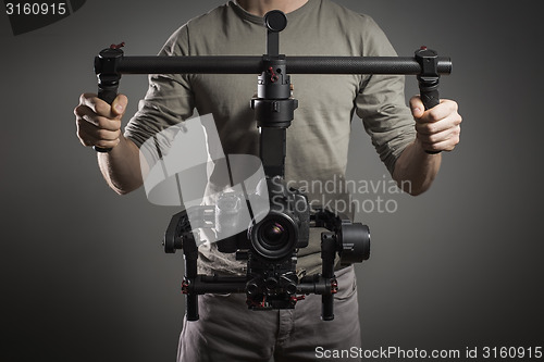 Image of Professional videographer with gimball video slr