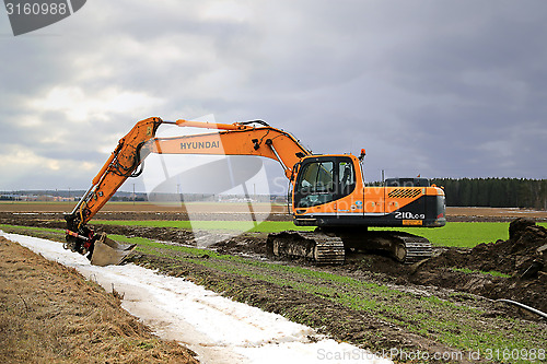 Image of  Hyundai Robex 210LC-9 Crawler Excavator on a Field at Spring