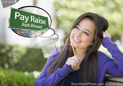 Image of Young Woman with Thought Bubble of Pay Raise Green Sign 