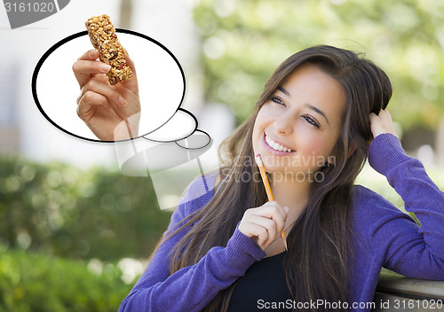 Image of Pensive Woman with Snack Bar Inside Thought Bubble