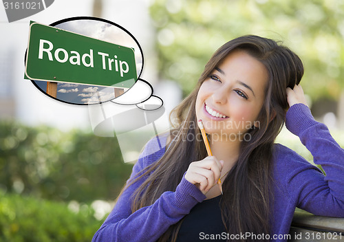 Image of Young Woman with Thought Bubble of Road Trips Green Sign 