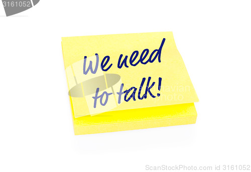 Image of Yellow sticky note on block with text We Need To Talk