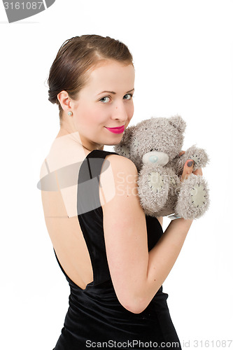 Image of attractive smiling brunette holding teddy bear
