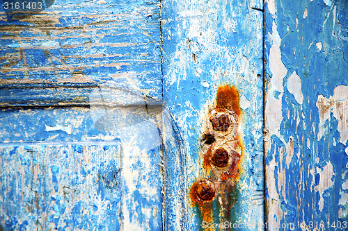 Image of   paint in the blue wood door rusty nail