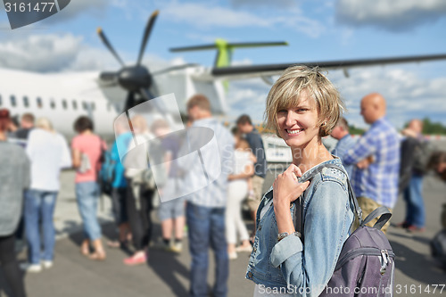 Image of Woman with backpack going on boarding