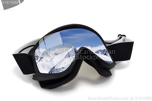 Image of Ski goggles with reflection of mountains at sun day