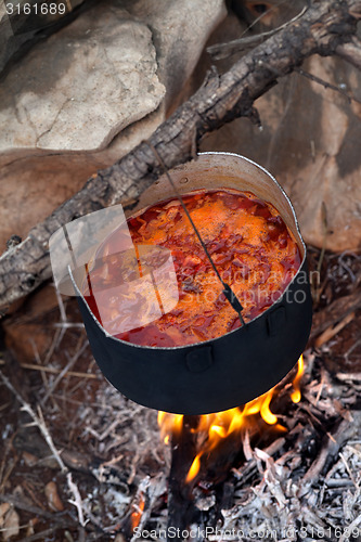 Image of Cooking borscht (Ukrainian soup) on campfire