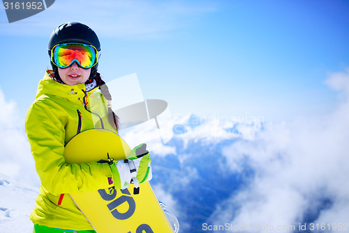 Image of View of sportsman with snowboard standing in the mountain