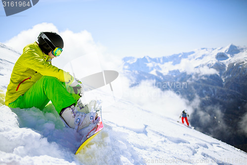 Image of Snowboarder sitting