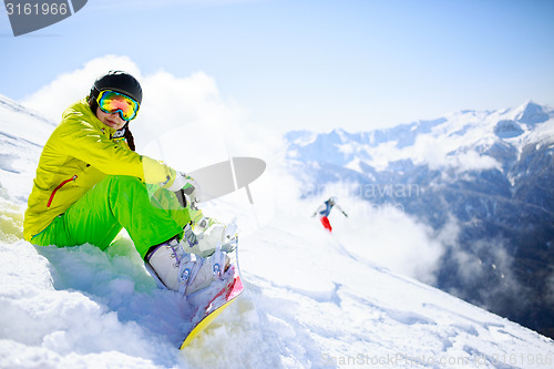 Image of Snowboarder sitting