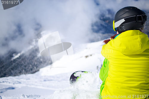 Image of Snowboarder sitting