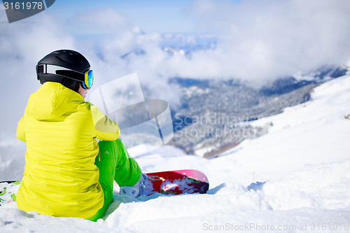 Image of Snowboarder sitting