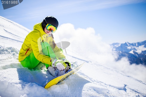 Image of Snowboarder sitting