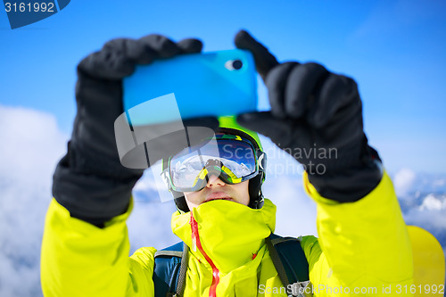 Image of Man in winter clothes taking a selfie