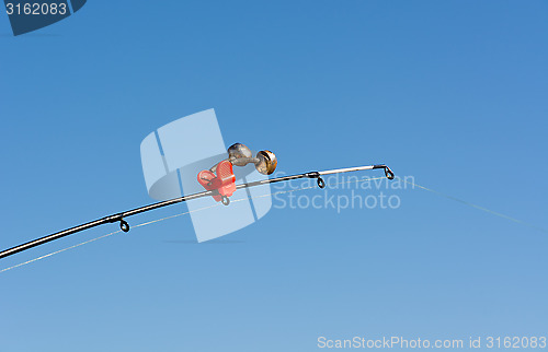 Image of Tip of fishing rod with a bell.