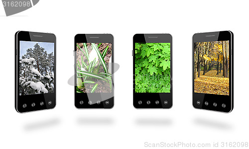 Image of four smart-phones with colored images of seasons