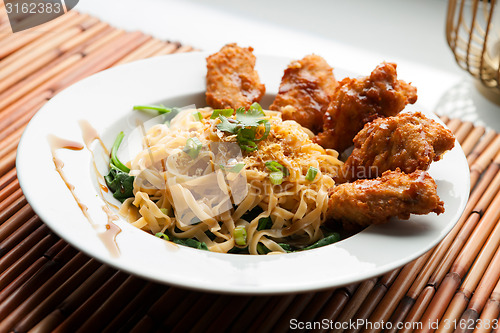 Image of Chicken Wings with Noodles and Spinach